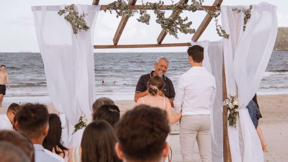 A couple exchanges vows during a beautiful beach wedding ceremony in Brazil.