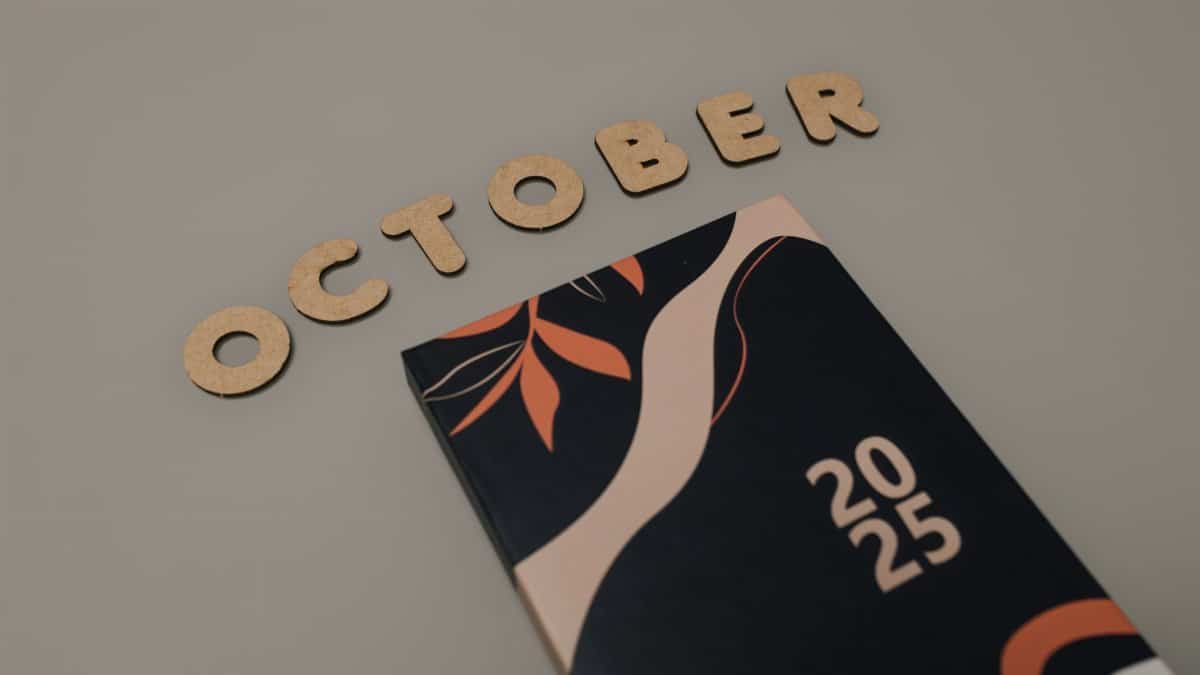 Stylized 2025 calendar with October written in wooden letters, perfect for planning and organization.