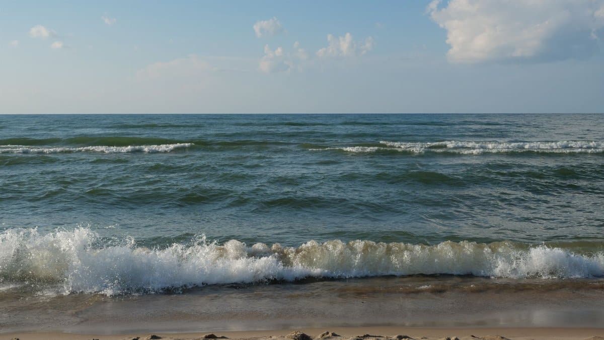 Peaceful view of Lake Michigan waves hitting the sandy shores at Portage, Indiana.