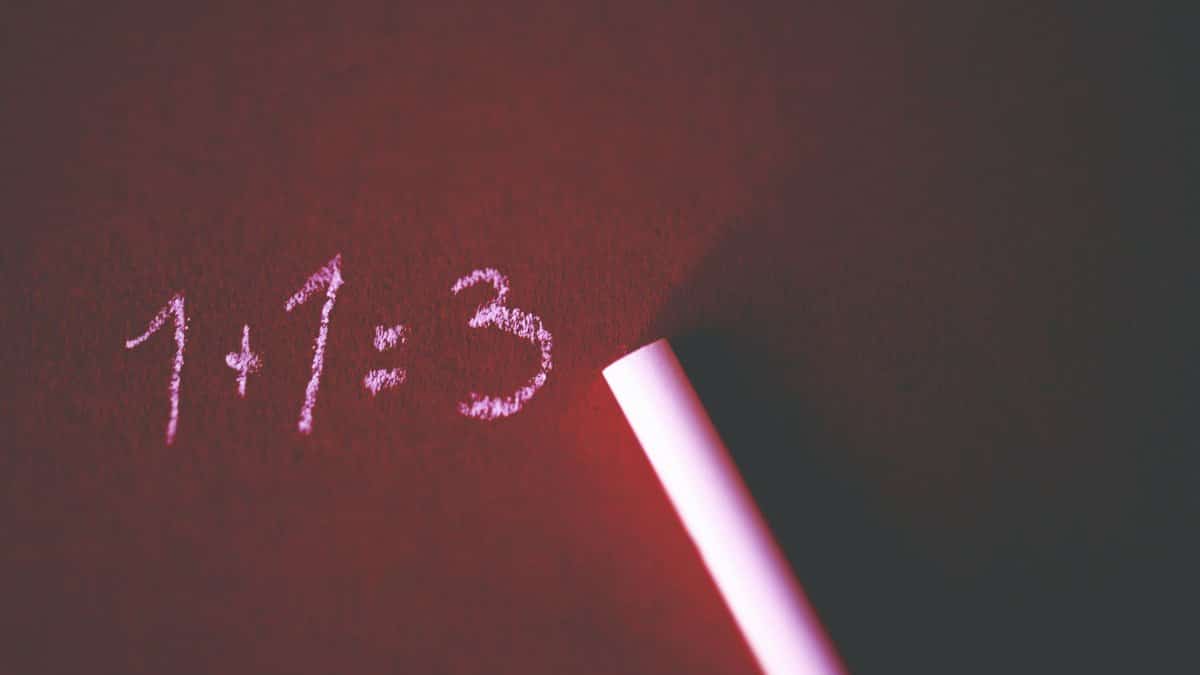 Close-up of a chalkboard with a humorous math error showing 1+1=3 written in chalk.