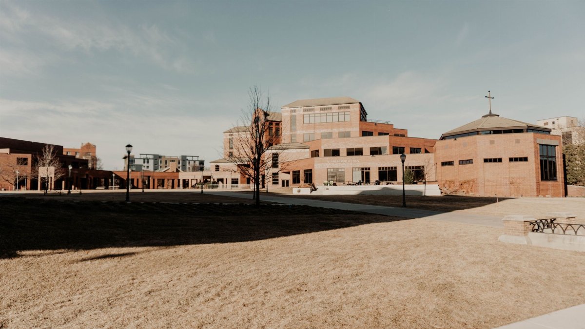 A wide-angle view of modern brick buildings in Milwaukee under a clear sky.