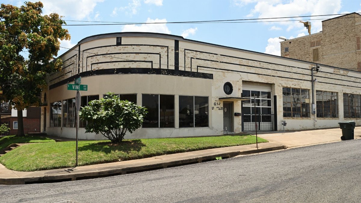 Vintage Art Deco building corner view in Tyler, Texas under a sunny sky.
