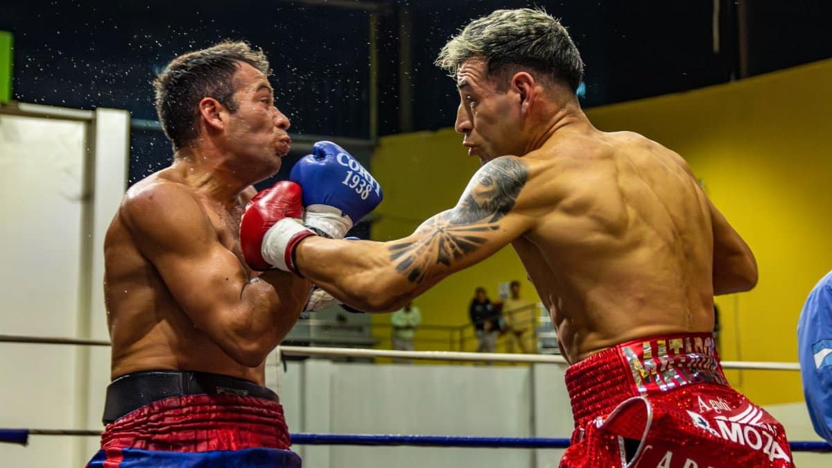 Intense boxing match with two fighters exchanging powerful punches.