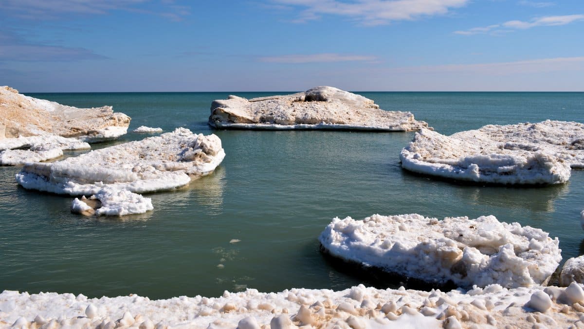 Ice slabs on Lake Michigan's shore create a stunning winter scene.