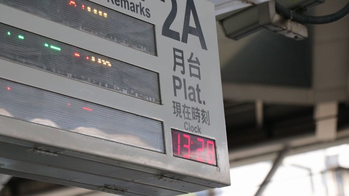 Close-up of an electronic train platform sign showing time and information.