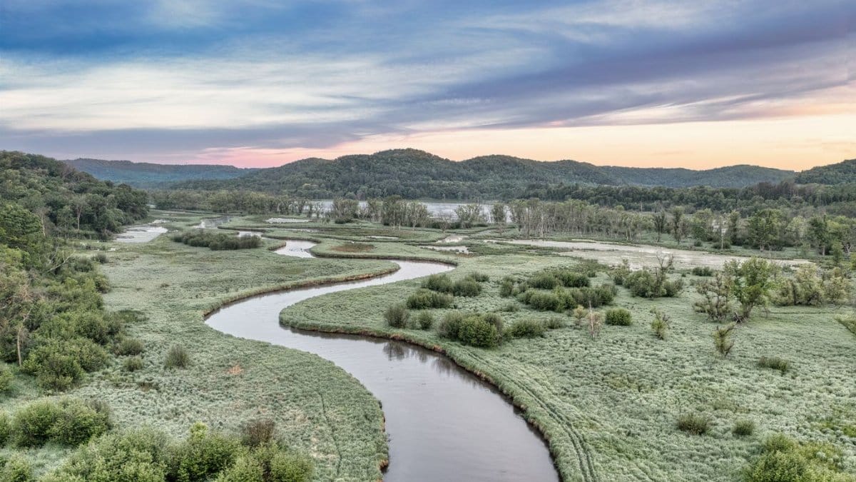 A scenic view of a meandering river through lush greenery in Tell, Wisconsin.
